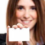 Business woman holding a blank card