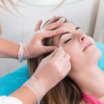 Woman getting tweezing eyebrow